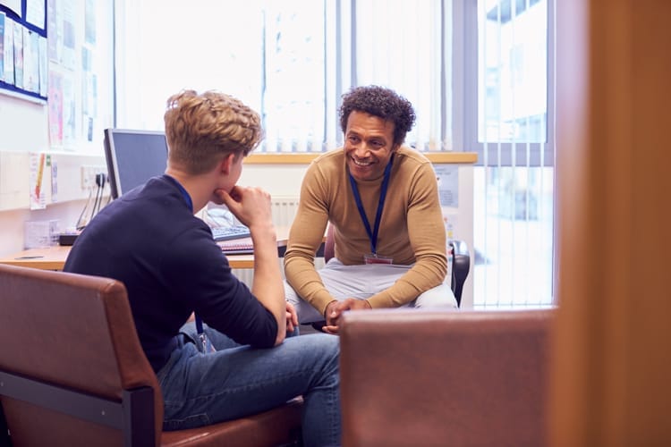 Two men discussing their compliance training strategy