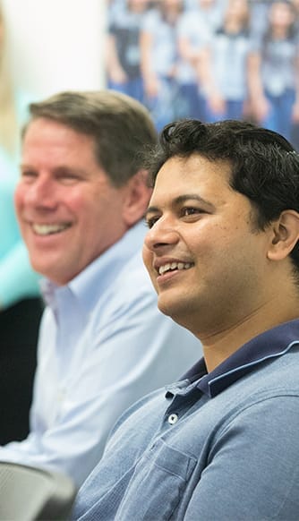 Colleagues smiling during a team meeting