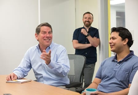 People in a conference room discussing a project idea