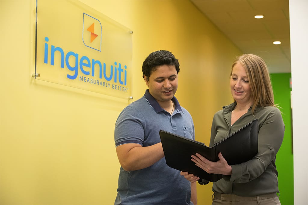 man and woman reviewing a content development design document